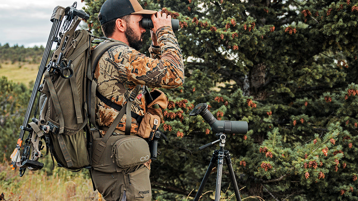hunter using binoculars and spotting scope with Magview phone adaptor.