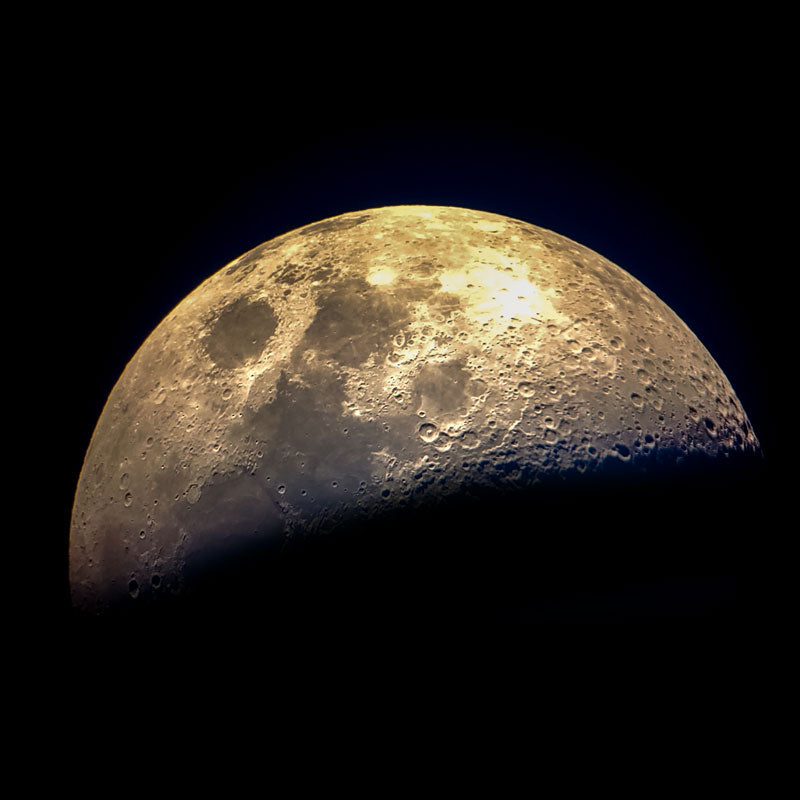 Half-moon with visible craters against a black background