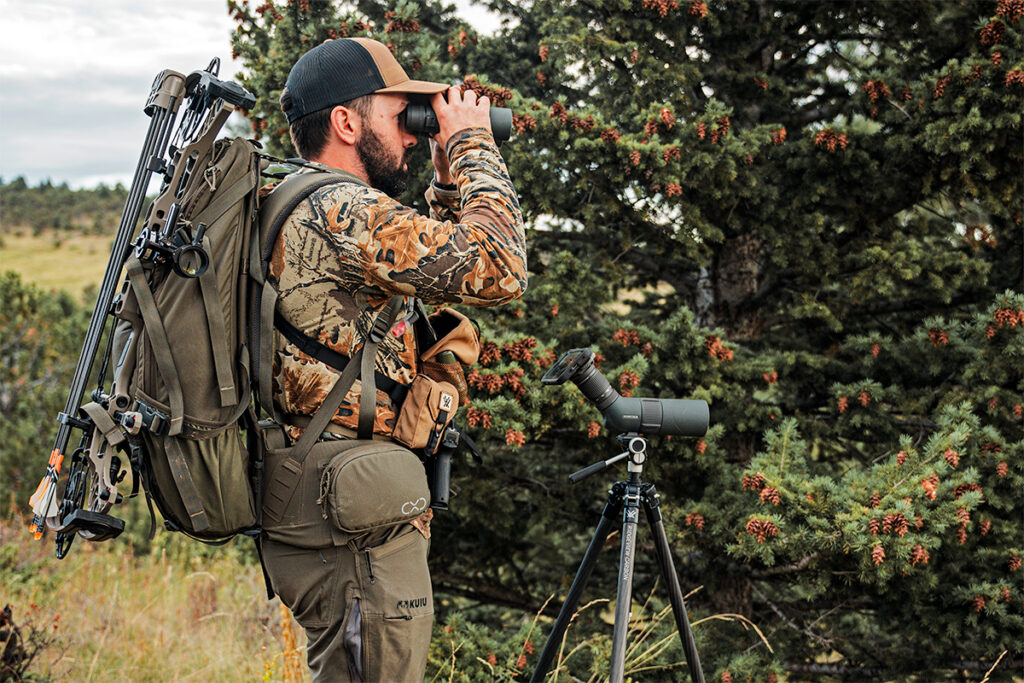 hunter using binoculars and spotting scope with Magview phone adaptor.